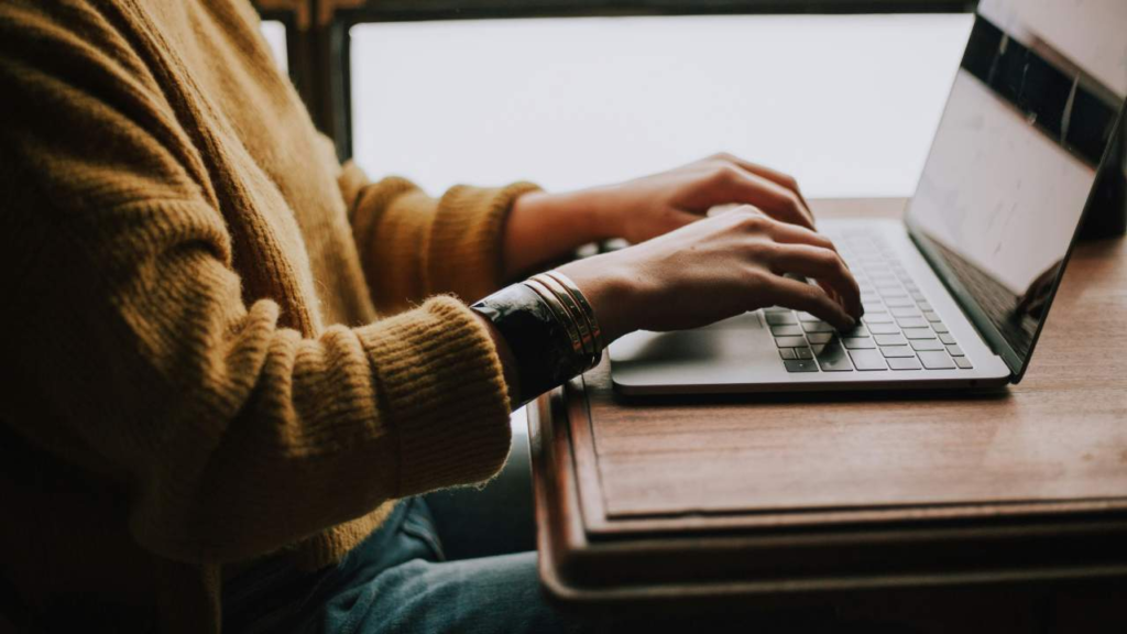 person typing on keyboard background